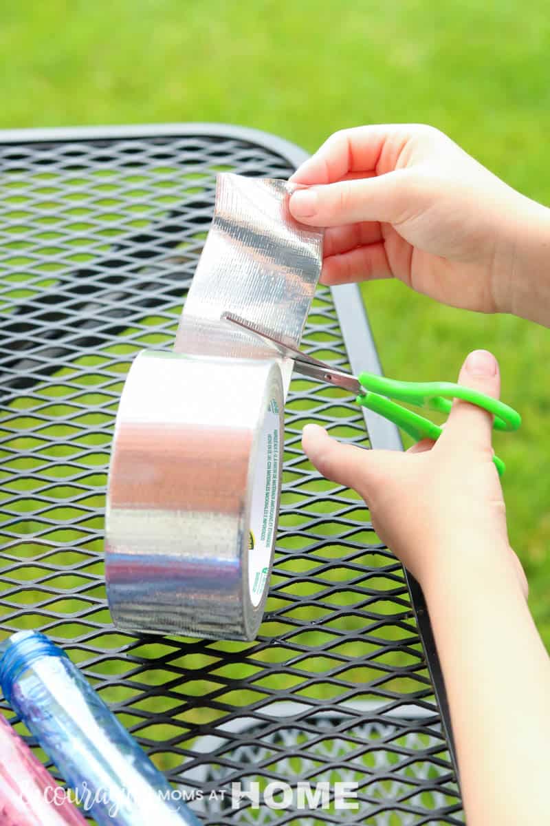 Child cutting duct tape