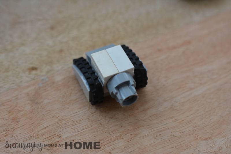 A white mini Lego tank squares off.