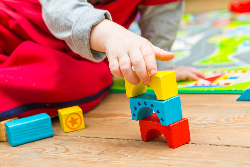 Child playing with blocks in preschool.